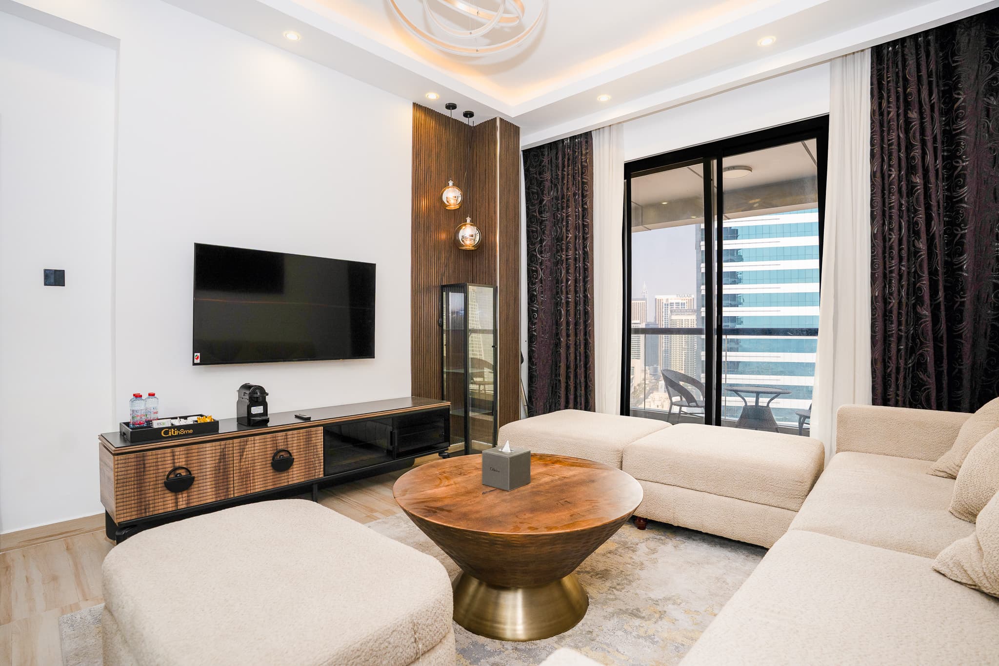 Furnished living room with a Dubai Marina skyline view from the balcony